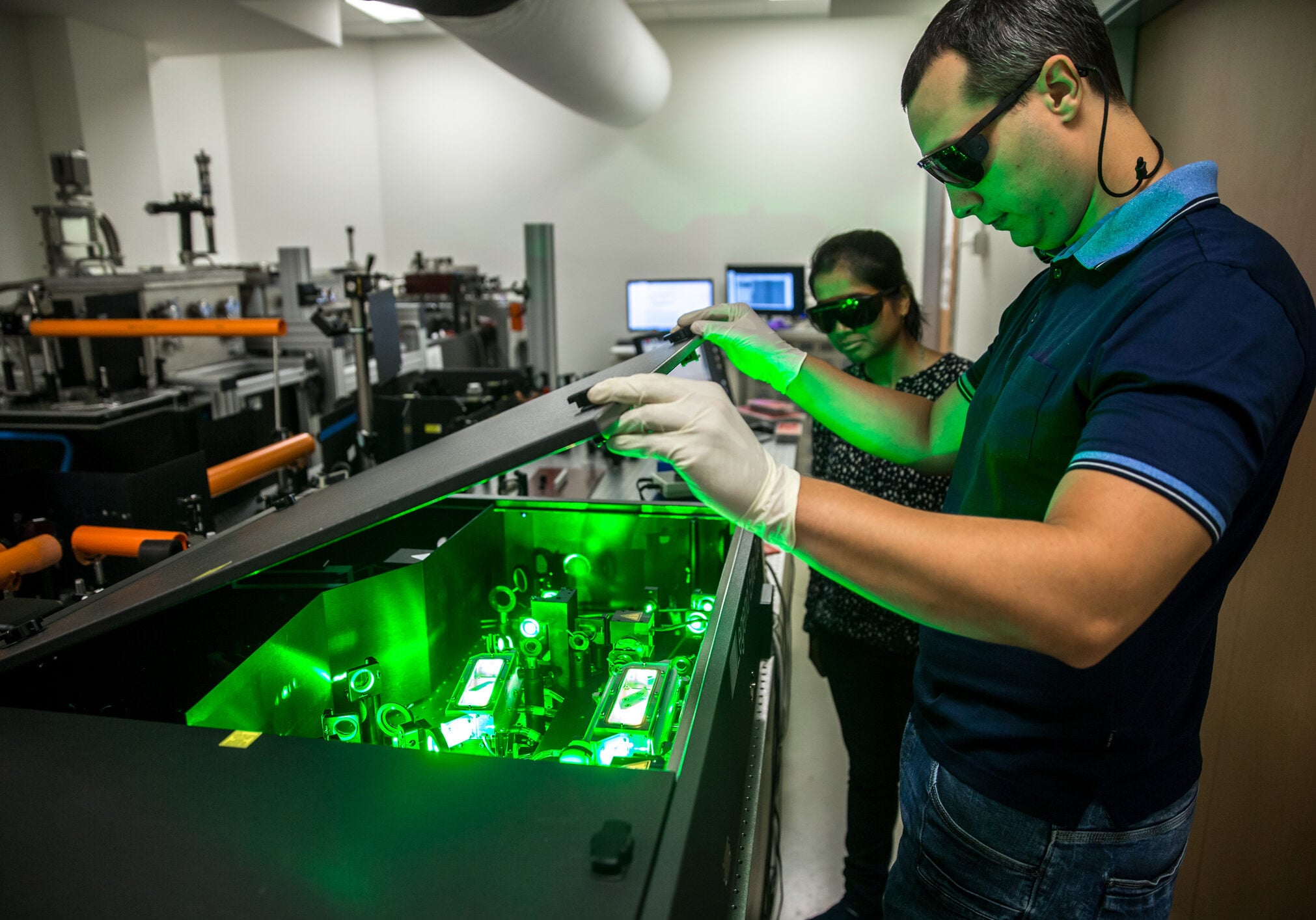 Multi-ethnic Group of Researchers Using Powerful High Frequency Laser used for new materials research.